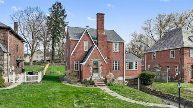 210 Morewood Rd, Shaler, PA 15116 - back of property featuring a chimney, brick siding, fence, a garage, and a lawn