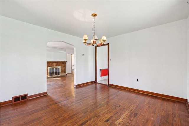 210 Morewood Rd, Shaler, PA 15116 - spare room featuring a notable chandelier, visible vents, baseboards, arched walkways, and wood finished floors