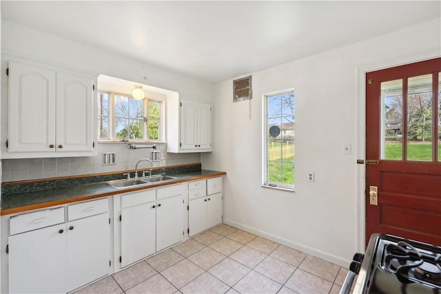 210 Morewood Rd, Shaler, PA 15116 - kitchen featuring dark countertops, a healthy amount of sunlight, white cabinetry, and a sink