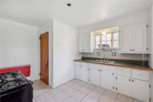 210 Morewood Rd, Shaler, PA 15116 - kitchen featuring white cabinetry, dark countertops, a sink, and gas stove