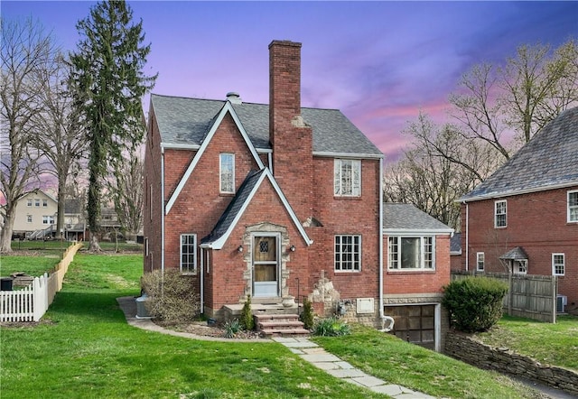 210 Morewood Rd, Shaler, PA 15116 - view of front of home featuring a garage, a yard, a chimney, brick siding, and fence