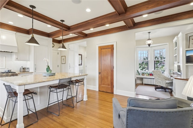 918 W Waldheim Rd, Fox Chapel, PA 15215 - kitchen featuring light wood finished floors, white cabinetry, beam ceiling, light stone countertops, and radiator