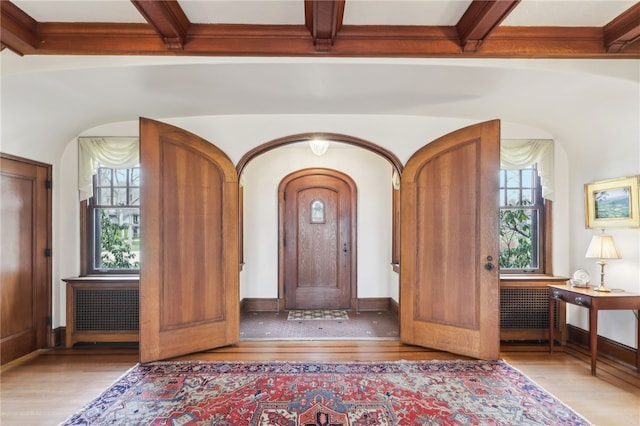 918 W Waldheim Rd, Fox Chapel, PA 15215 - foyer featuring arched walkways, wood finished floors, radiator, beamed ceiling, and baseboards