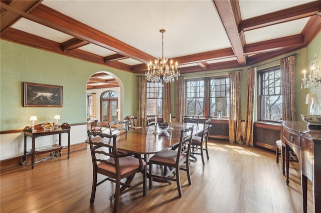918 W Waldheim Rd, Fox Chapel, PA 15215 - dining room featuring a chandelier, arched walkways, wood finished floors, coffered ceiling, and plenty of natural light