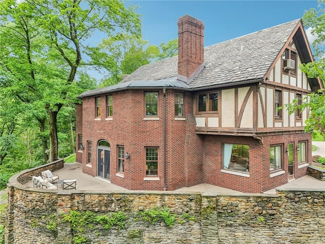 918 W Waldheim Rd, Fox Chapel, PA 15215 - rear view of property with a chimney, a patio, brick siding, stucco siding, and cooling unit