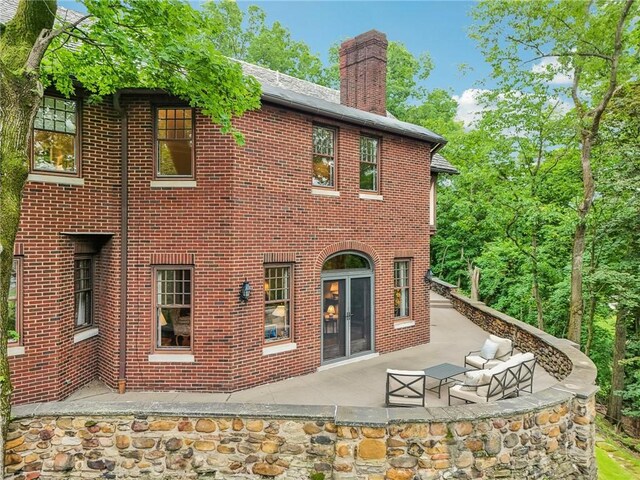 918 W Waldheim Rd, Fox Chapel, PA 15215 - rear view of property featuring a chimney, brick siding, and a patio