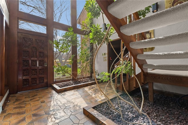 interior space featuring a wealth of natural light and stone finish floor