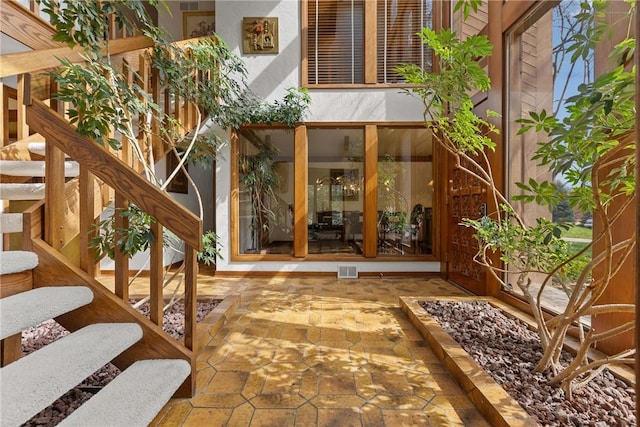 entrance to property with a patio and stucco siding