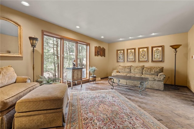 living room featuring baseboards and recessed lighting