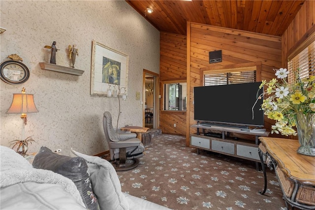 carpeted living area with wood walls and wooden ceiling