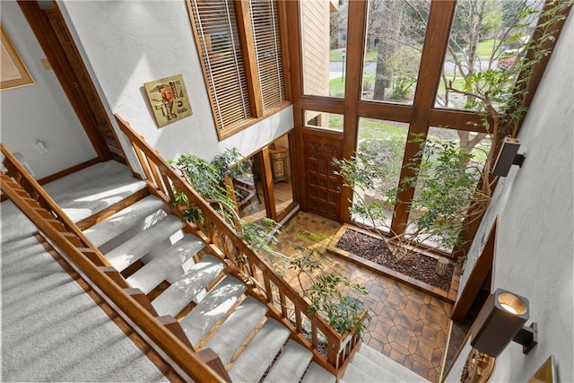 stairway featuring a textured wall