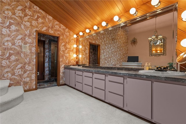 full bathroom featuring a sink, double vanity, vaulted ceiling, and wallpapered walls