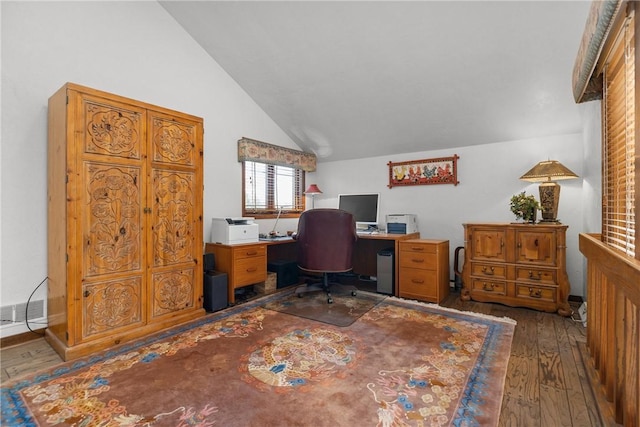 home office with visible vents, hardwood / wood-style floors, and lofted ceiling