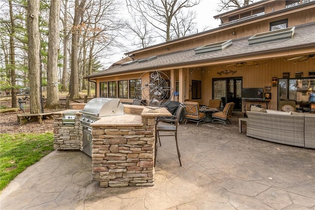 view of patio / terrace featuring exterior kitchen, outdoor lounge area, and a grill