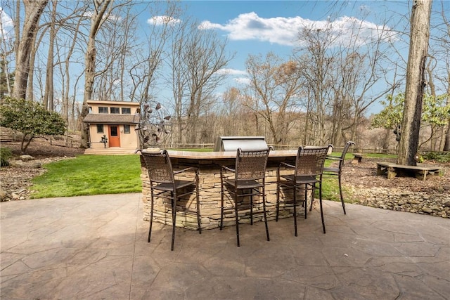 view of patio with an outdoor structure and outdoor dry bar