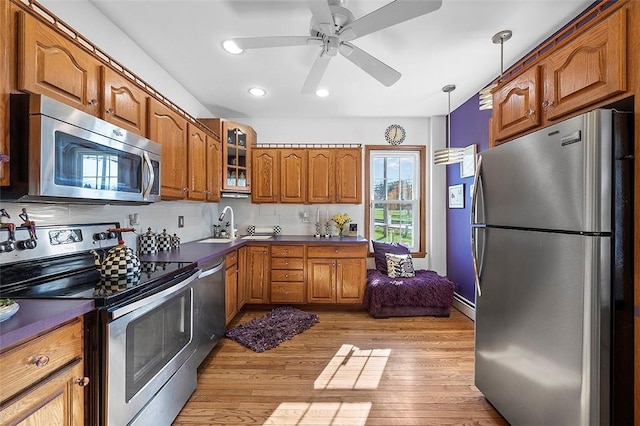 1556 W Ingomar Rd, Franklin Park, PA 15237 - kitchen featuring appliances with stainless steel finishes, brown cabinets, dark countertops, glass insert cabinets, and recessed lighting