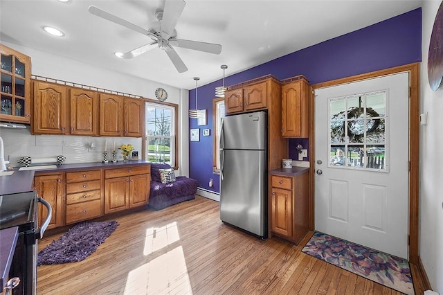1556 W Ingomar Rd, Franklin Park, PA 15237 - kitchen with freestanding refrigerator, brown cabinetry, light wood finished floors, a ceiling fan, and range with electric stovetop