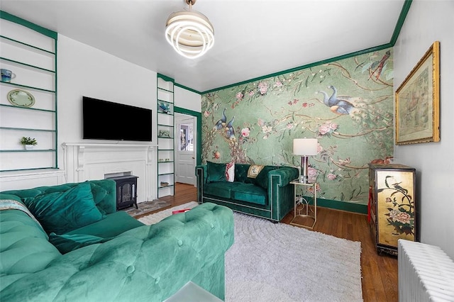 1556 W Ingomar Rd, Franklin Park, PA 15237 - living area featuring wood finished floors, radiator, built in shelves, a fireplace with flush hearth, and baseboards