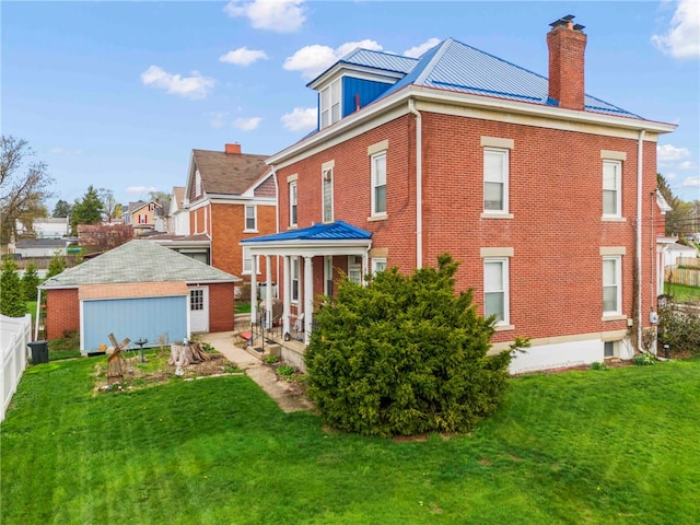 101 Cherry Ave, Houston, PA 15342 - back of house with a chimney, brick siding, an outbuilding, fence, and a lawn