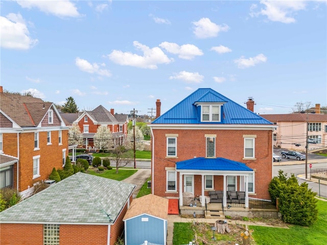 101 Cherry Ave, Houston, PA 15342 - rear view of property with a standing seam roof, brick siding, a chimney, and metal roof