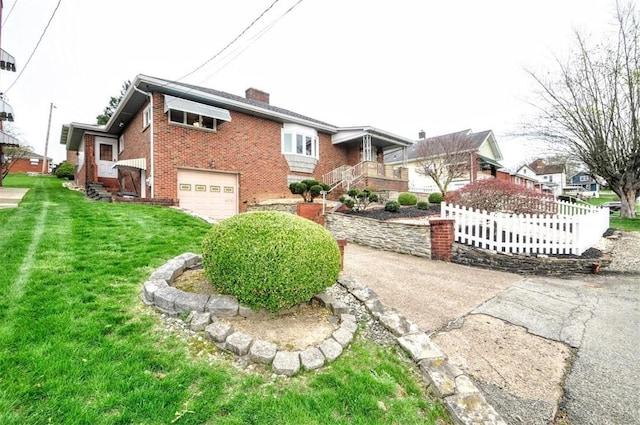 exterior space featuring a garage, a chimney, fence, brick siding, and a front lawn