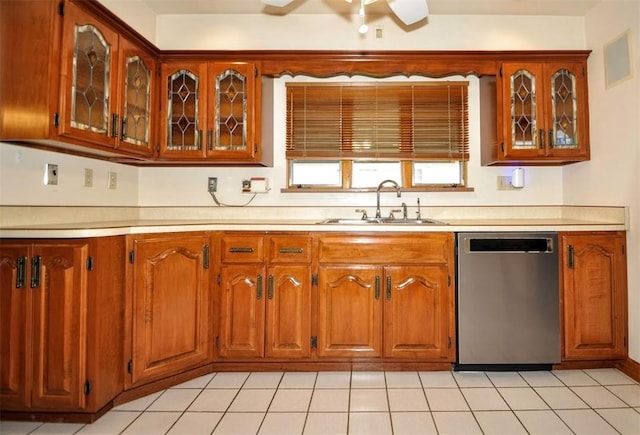 kitchen with brown cabinetry, dishwasher, light countertops, and a sink