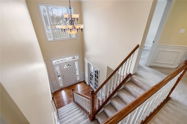 107 Stafford Ct, Ohio Twp, PA 15237 - foyer featuring a high ceiling, a chandelier, stairway, wainscoting, and wood finished floors