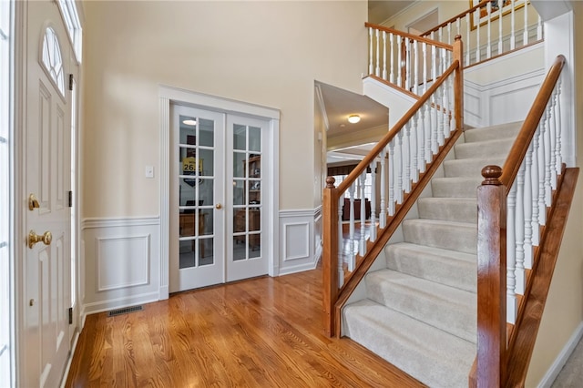107 Stafford Ct, Ohio Twp, PA 15237 - entryway featuring visible vents, french doors, wood finished floors, and stairs