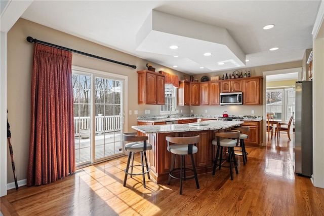 107 Stafford Ct, Ohio Twp, PA 15237 - kitchen featuring a wealth of natural light, appliances with stainless steel finishes, a kitchen island, and light wood finished floors