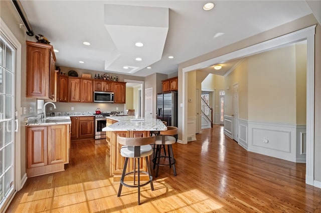 107 Stafford Ct, Ohio Twp, PA 15237 - kitchen with light wood-style flooring, a center island, a sink, and appliances with stainless steel finishes