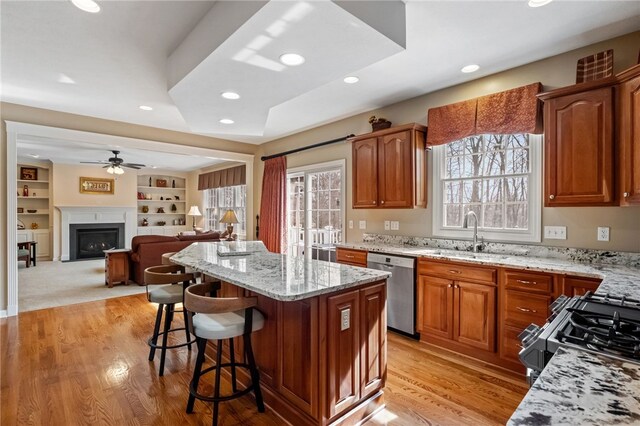107 Stafford Ct, Ohio Twp, PA 15237 - kitchen with a kitchen island, light stone countertops, a kitchen bar, ceiling fan, and stainless steel dishwasher
