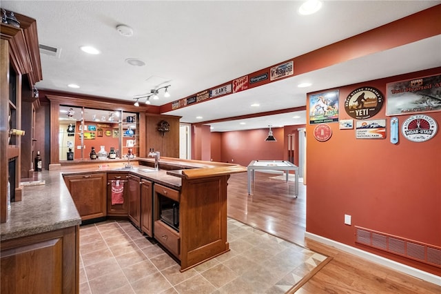 107 Stafford Ct, Ohio Twp, PA 15237 - kitchen featuring brown cabinetry, a peninsula, visible vents, light wood finished floors, and built in microwave