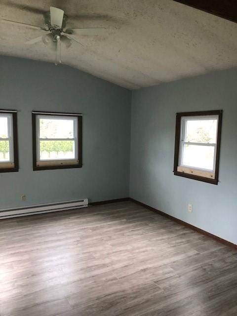 23 Gilmore Ln, Sandy Lake Twp, PA 16153 - empty room featuring wood finished floors, a ceiling fan, baseboards, baseboard heating, and lofted ceiling