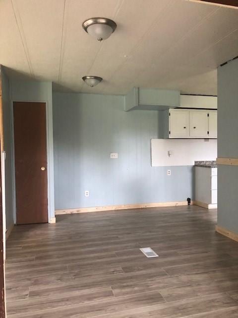 23 Gilmore Ln, Sandy Lake Twp, PA 16153 - unfurnished living room featuring wood finished floors and baseboards