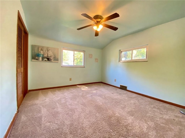 empty room with ceiling fan, carpet flooring, baseboards, and a healthy amount of sunlight