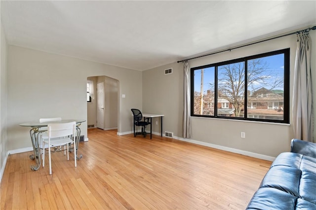 interior space with visible vents, light wood-type flooring, and baseboards