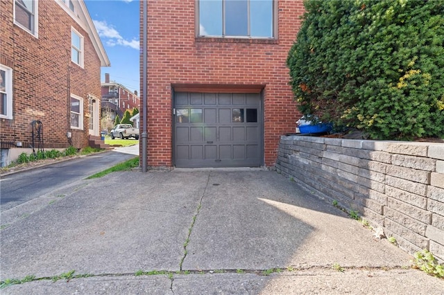 garage featuring concrete driveway