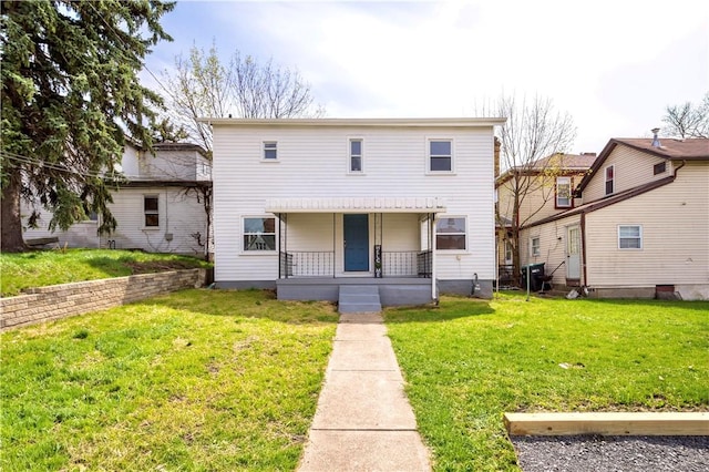 view of front of home with a front yard and covered porch