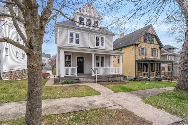 traditional style home with a front yard and a porch
