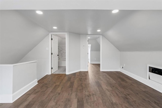 additional living space featuring wood finished floors, baseboards, vaulted ceiling, and recessed lighting