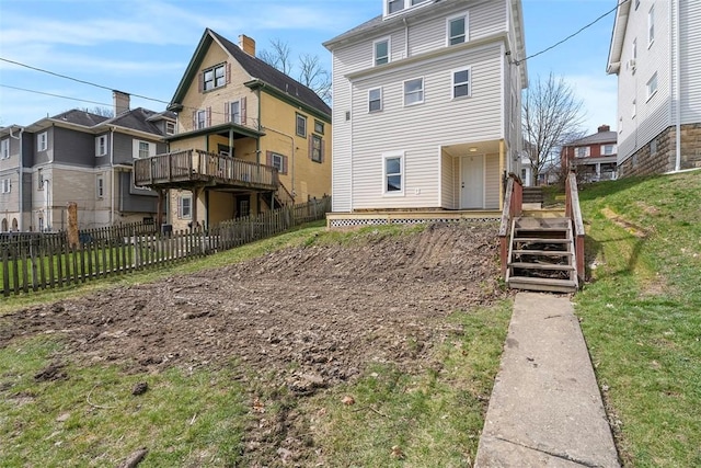 rear view of house with a residential view and fence