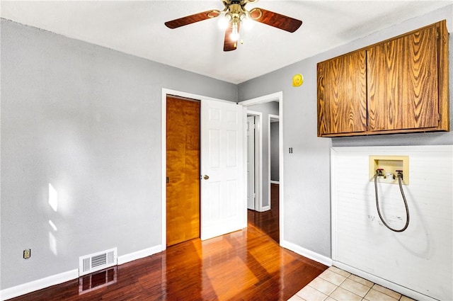 interior space with light wood finished floors, visible vents, a ceiling fan, and baseboards