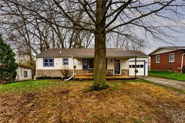 ranch-style home with a front lawn, driveway, stone siding, a garage, and board and batten siding
