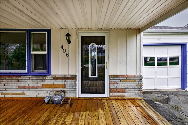 doorway to property featuring stone siding and covered porch