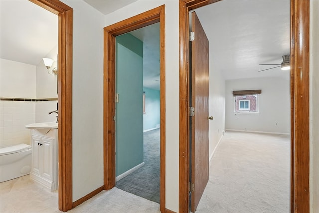 285 Park Entrance Dr, Mt Lebanon, PA 15228 - hallway with light carpet, a sink, and baseboards