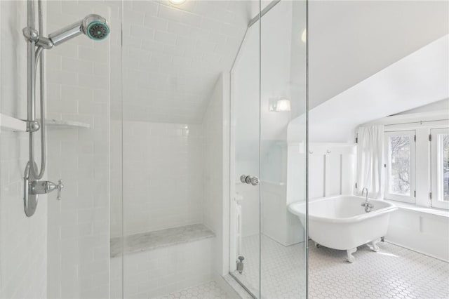 full bath with tile patterned floors, a freestanding tub, and a stall shower