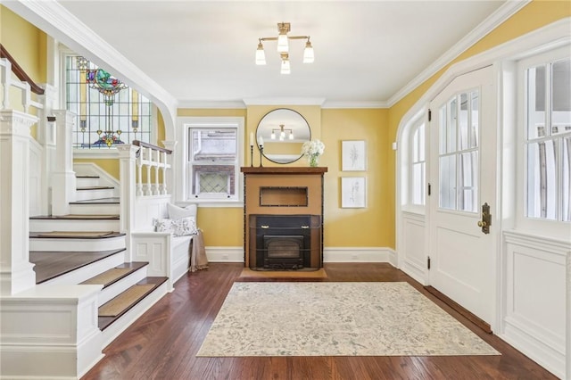 entryway featuring ornamental molding, baseboards, stairway, and dark wood-style floors