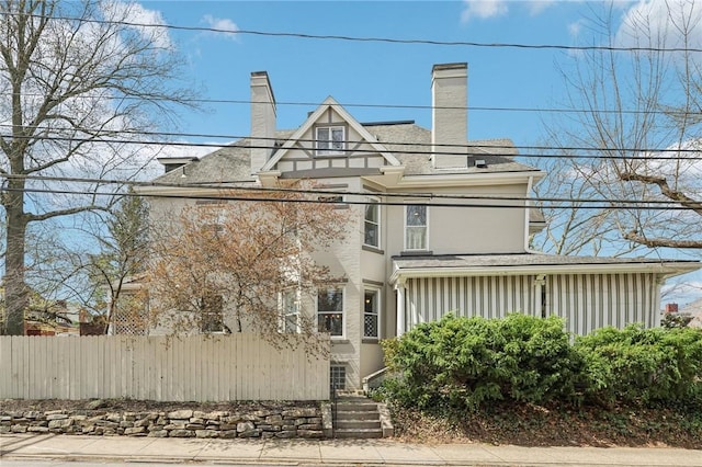 view of front of home featuring fence and stucco siding