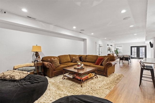 living area featuring french doors, visible vents, recessed lighting, and light wood-style floors