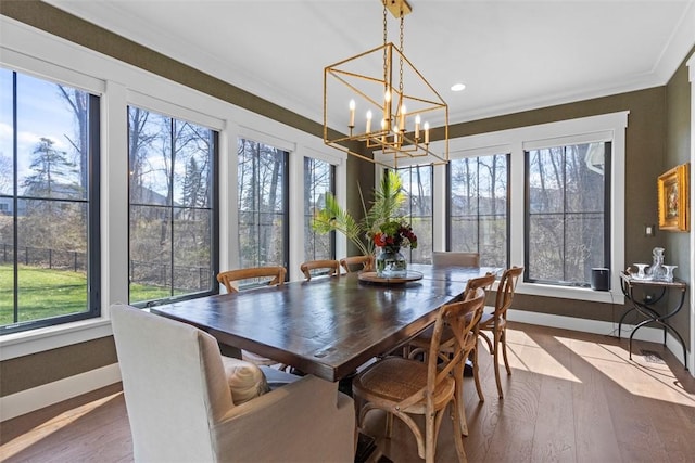 dining area with crown molding and wood finished floors
